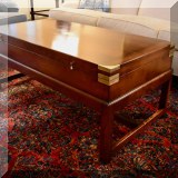 F04. Chest on stand coffee table with brass braces. 20”h x 48”w x 24”d 